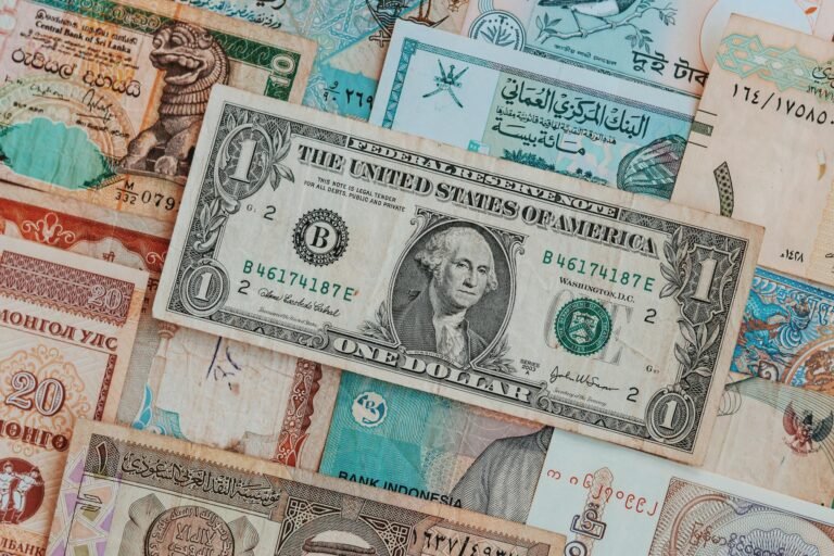 Close-up of various international banknotes creating a diverse currency background.